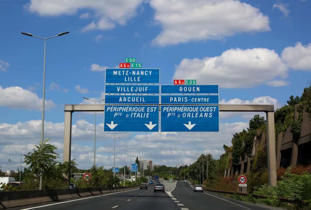 Blue French Motorway signs above the carriageway